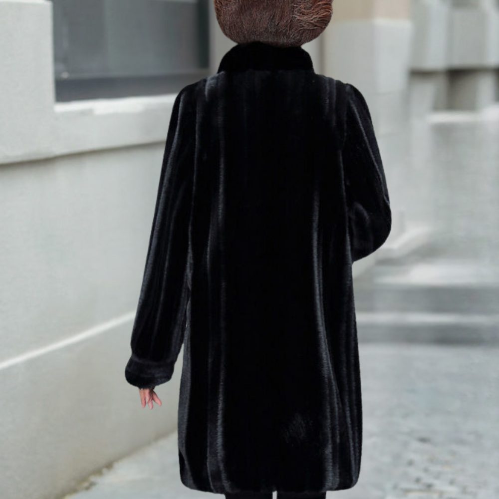 Back view of women's black A-line faux-fur coat