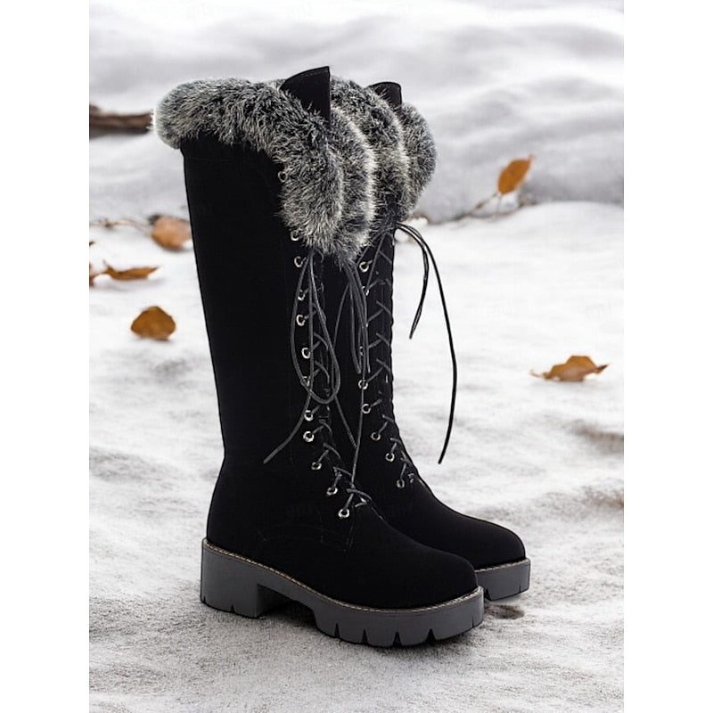Women's black lace-up knee-high platform boots in snow