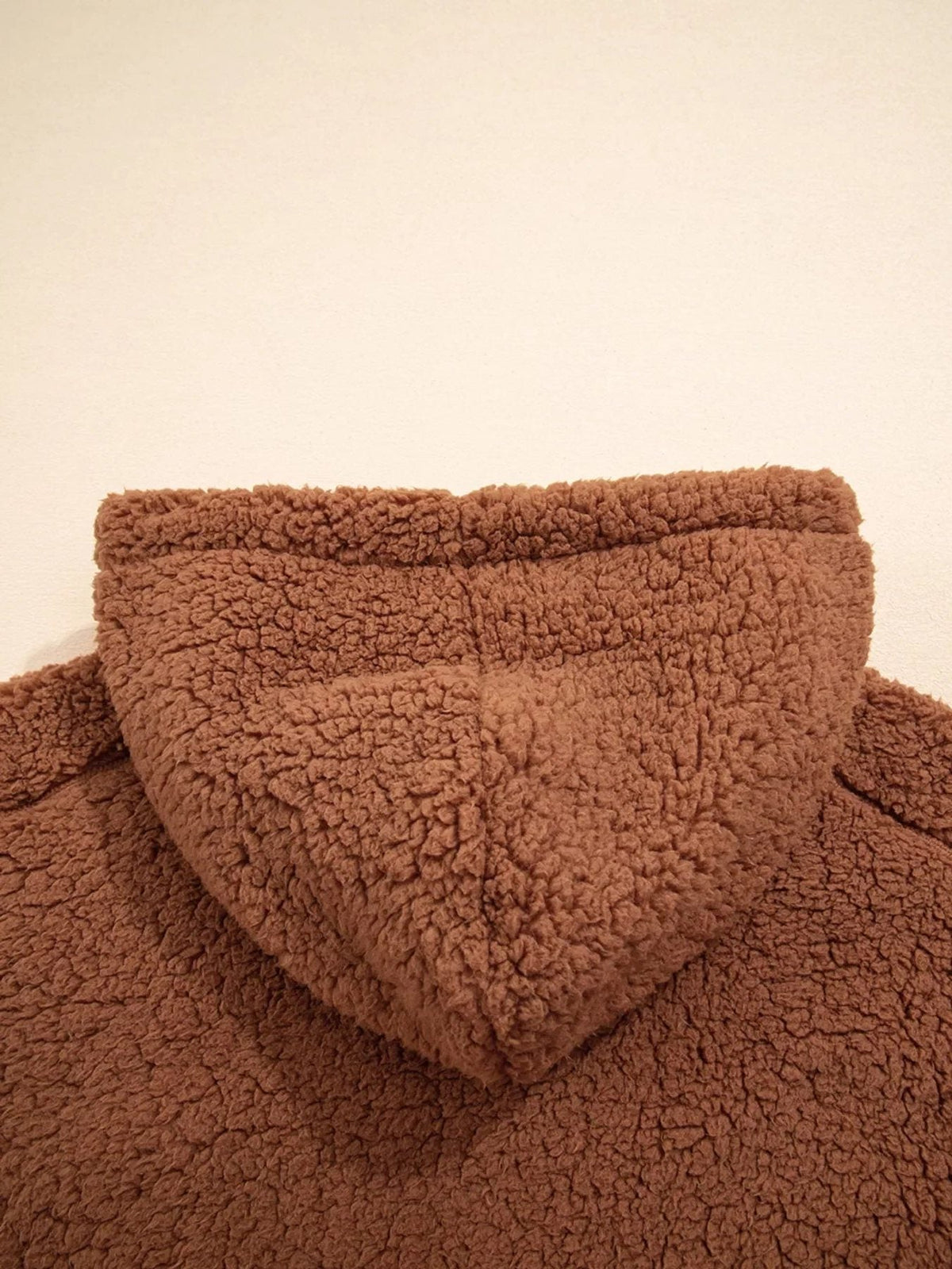 Back close-up of attached hood on women's brown teddy jacket